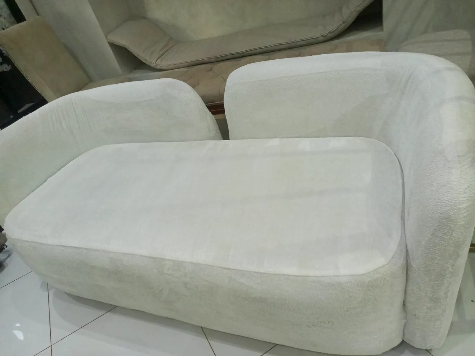 Close-up of a white upholstered armchair