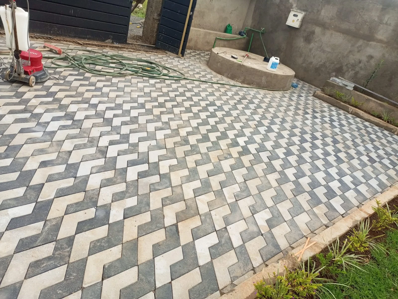 Cabro-paved courtyard with cleaning equipment and hoses