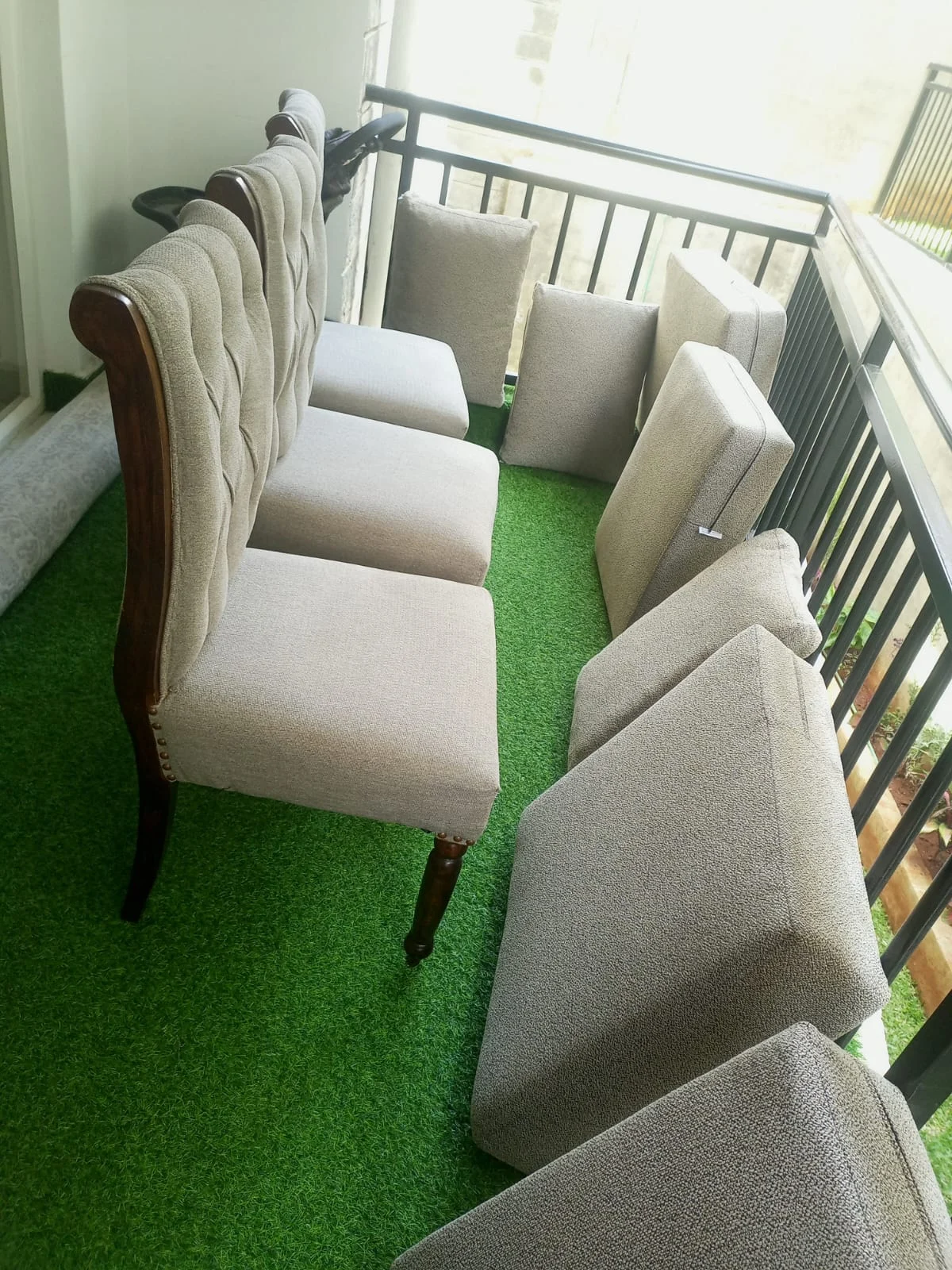 Upholstered dining chairs and cushions on a balcony
